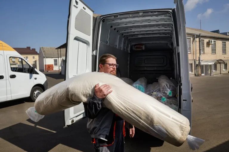 A man walking through a city, reflecting on the importance of a good mattress for health.