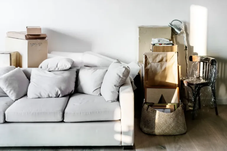A family packing boxes and moving to a new house, illustrating the need for cleanouts before relocation.